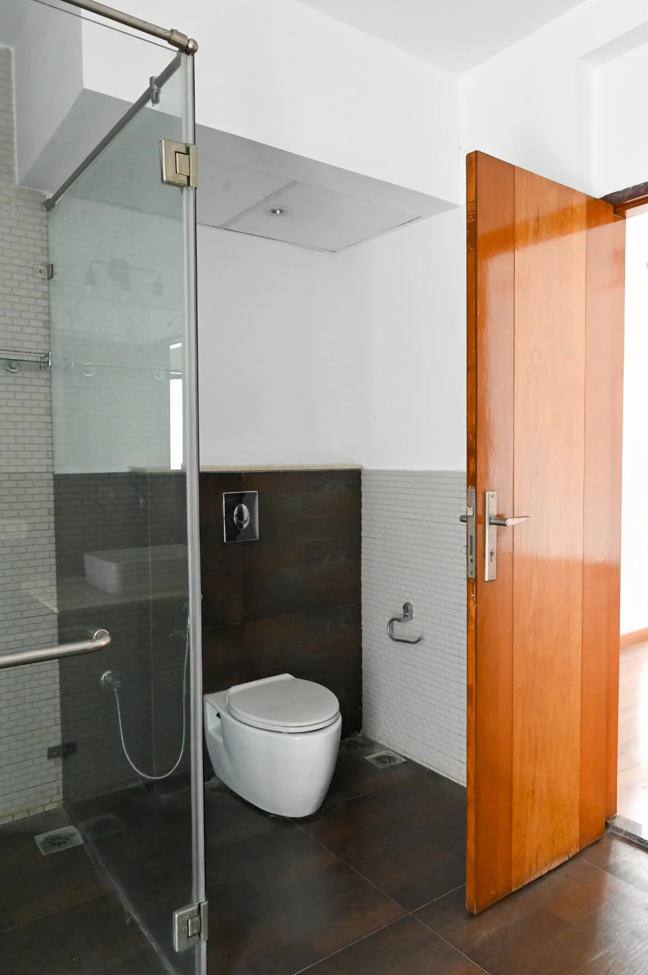 En-suite bathroom with walk-in glass shower and dark tiling, Prestige Laughing Waters luxury villa for rent, Whitefield, Bangalore