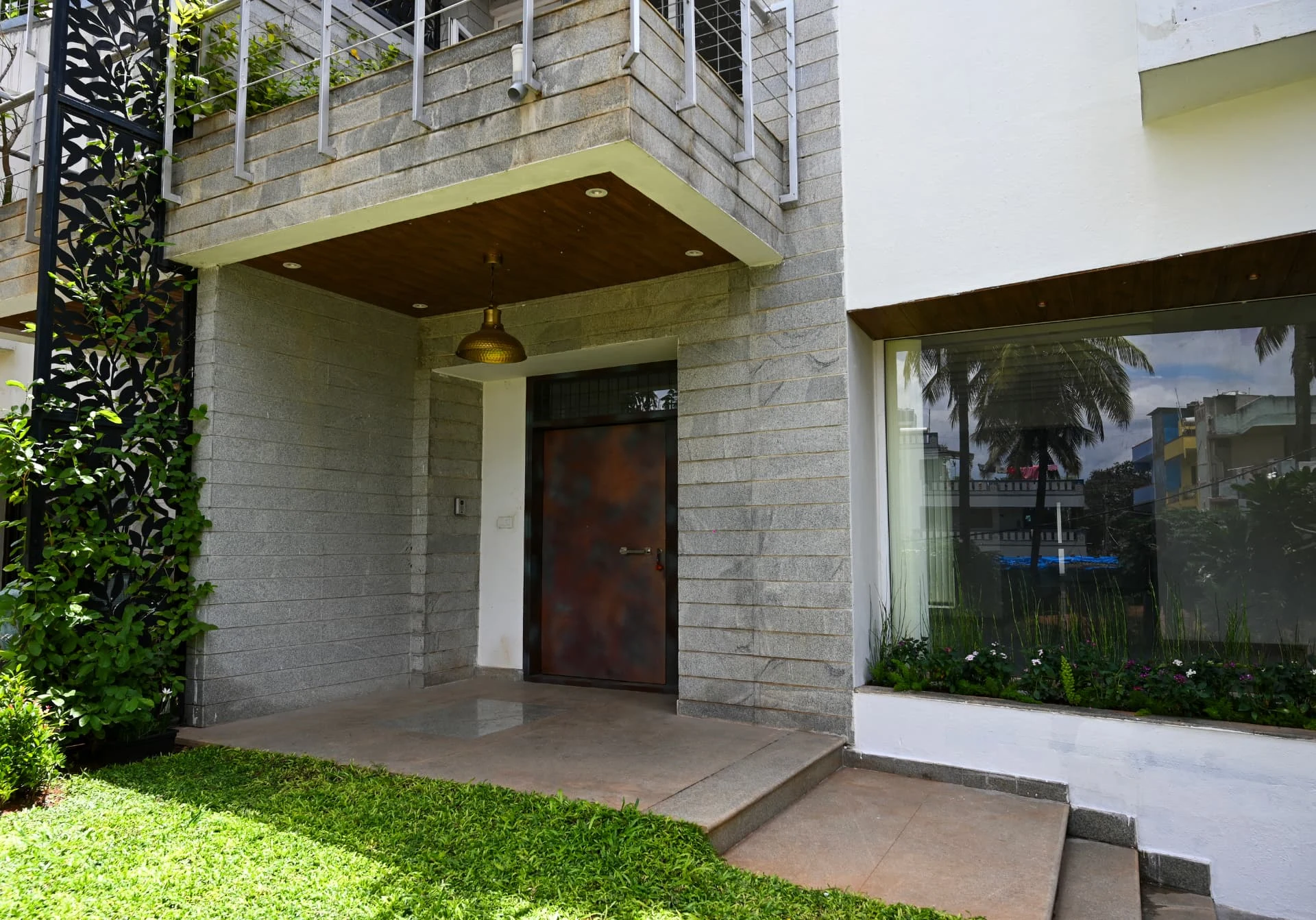 Granite-clad porch with copper front door and picture window, Prestige Laughing Waters luxury villa for rent, Whitefield, Bangalore