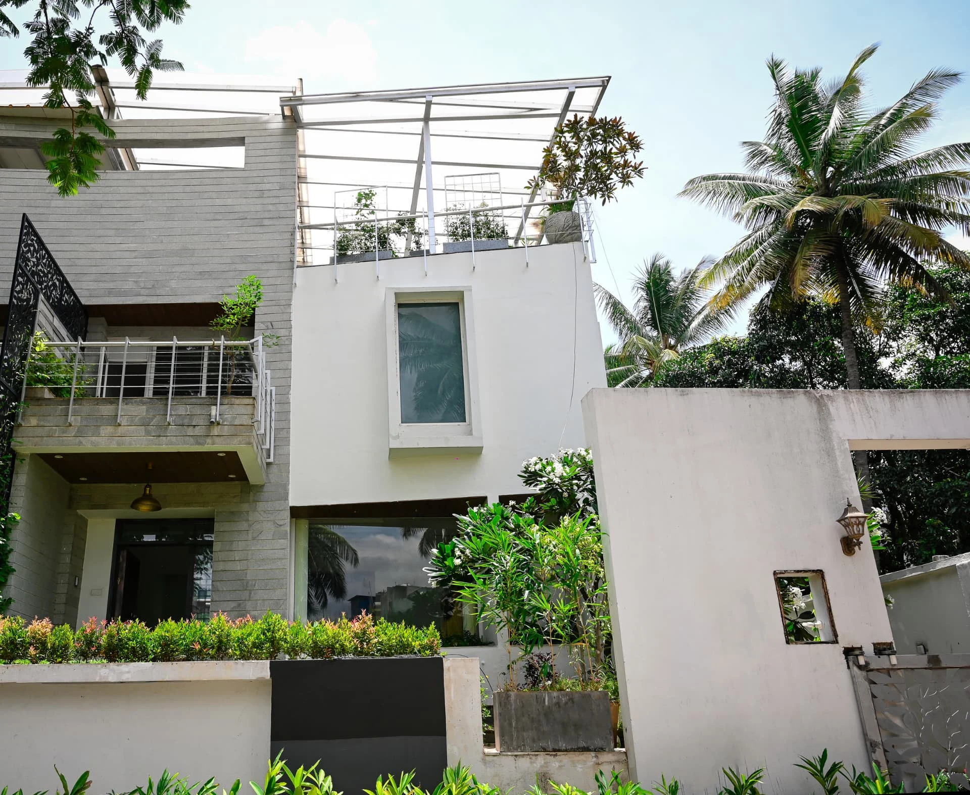 Side elevation showing granite cladding, terraces and roof garden, Prestige Laughing Waters luxury villa for rent, Whitefield, Bangalore