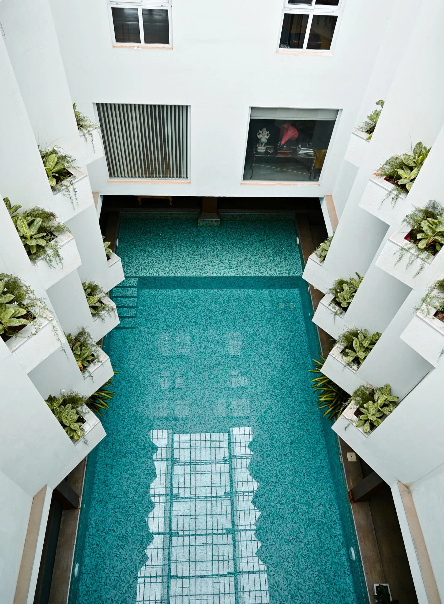 Indoor pool seen from the upper gallery, ringed by planters, Laughing Waters twin villas for sale, Whitefield, Bengaluru
